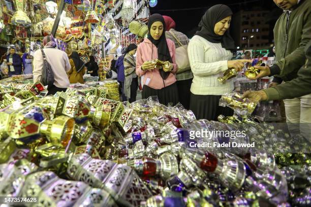 People buy traditional lanterns of the holy Muslim month of Ramadan at a market shop in the central Sayyida Zeinab district on March 14, 2023 in...