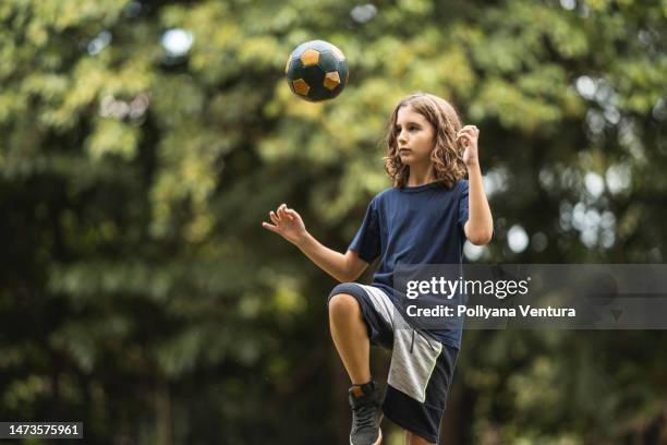 boy training soccer ball skills - bright future concept stock pictures, royalty-free photos & images
