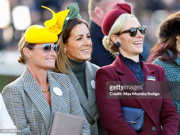 Dolly Maude, Natalie Pinkham and Zara Tindall watch the racing as they attend day 1 'Champion Day' of the Cheltenham Festival at Cheltenham...