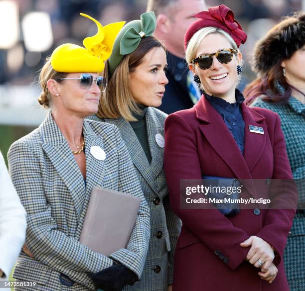 Dolly Maude, Natalie Pinkham and Zara Tindall watch the racing as they attend day 1 'Champion Day' of the Cheltenham Festival at Cheltenham...