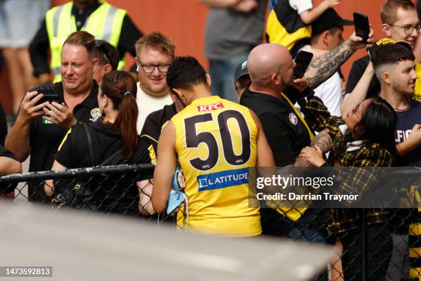 Marlion Pickett of the Tigers signs autographs during a Richmond Tigers AFL training session at Punt Road Oval on March 15, 2023 in Melbourne,...