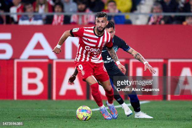 Valentin 'Taty' Castellanos of Girona FC is challenged by Jose Maria Gimenez of Atletico de Madrid during the LaLiga Santander match between Girona...