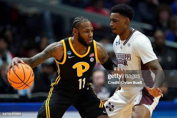 Jamarius Burton of the Pittsburgh Panthers dribbles against D.J. Jeffries of the Mississippi State Bulldogs during the first half in the First Four...