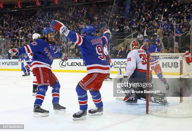 Mika Zibanejad of the New York Rangers celebrates his first period goal against the Washington Capitals and is joined by Vladimir Tarasenko and...