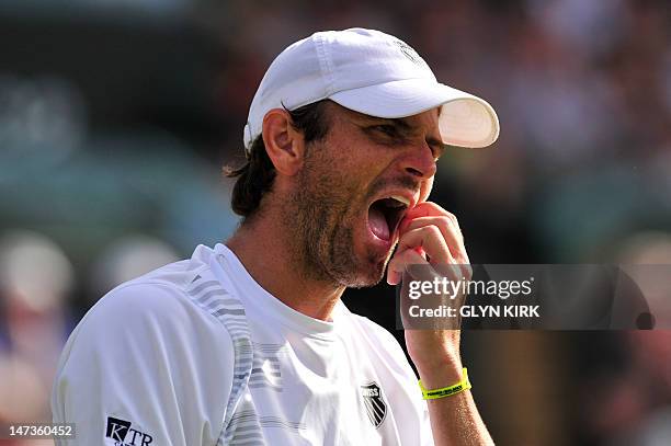 Player Mardy Fish reacts during his second round men's singles match against Britain's James Ward on day four of the 2012 Wimbledon Championships...