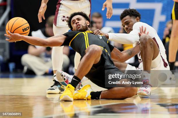 Nelly Cummings of the Pittsburgh Panthers and Dashawn Davis of the Mississippi State Bulldogs battle for the ball during the second half in the First...