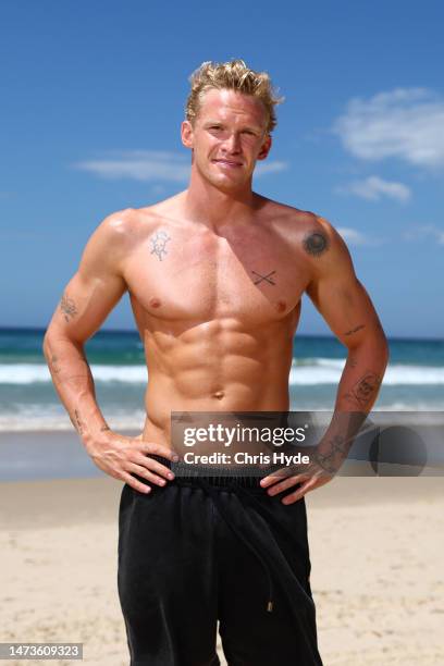 Cody Simpson poses during a beach safety demonstration alongside Surf Life Saving Australia lifesavers on March 15, 2023 in Gold Coast, Australia.