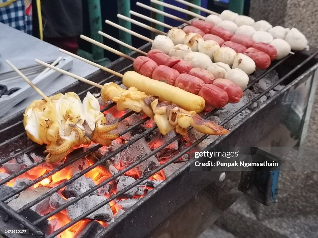 Squid Skewers Skewered sausages grilled on a charcoal grill