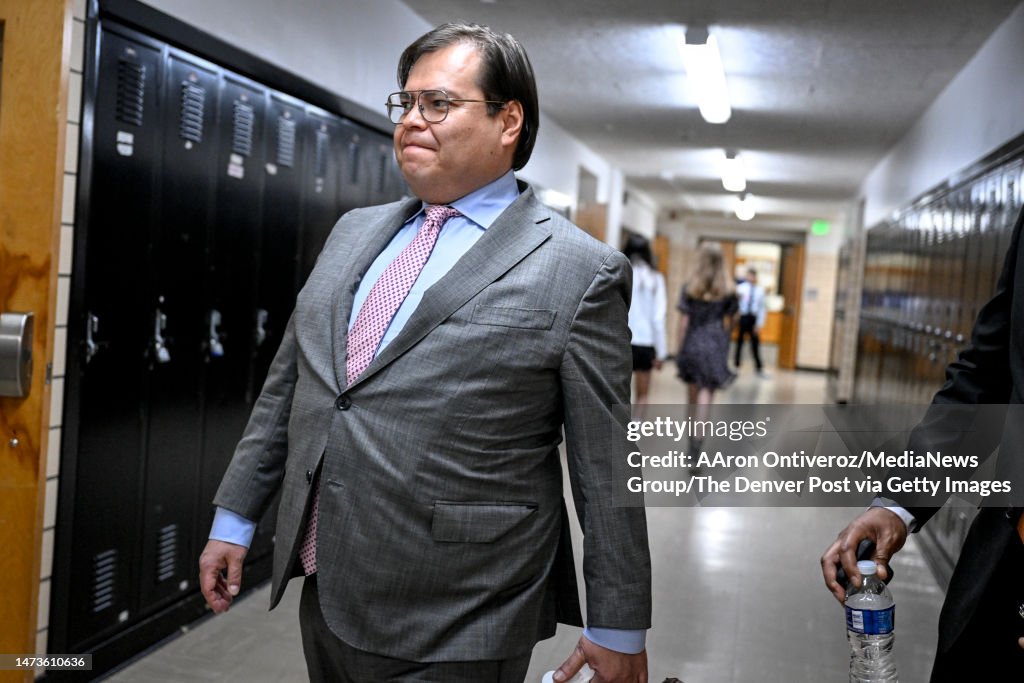 Trinidad Rodriguez walks down a hallway before a Denver city mayoral