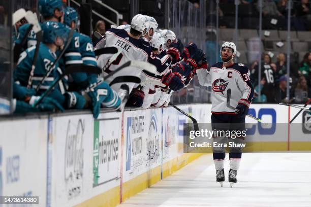 Boone Jenner of the Columbus Blue Jackets is congratulated by teammates after he scored a goal in the second period against the San Jose Sharks at...