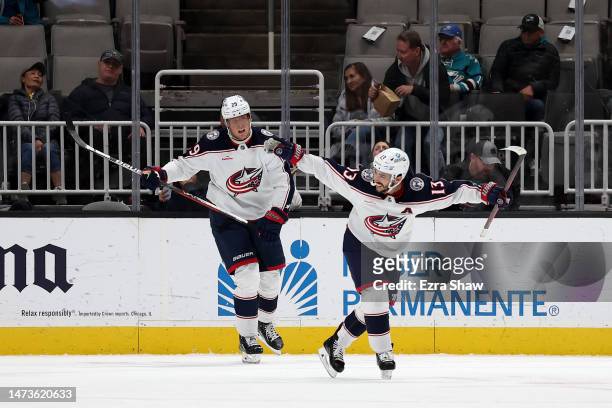 Johnny Gaudreau and Patrik Laine of the Columbus Blue Jackets celebrate after Gaudreau scored the winning goal against the San Jose Sharks in...
