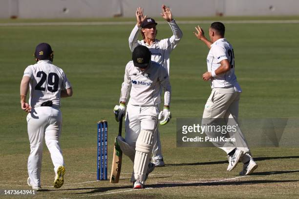 Campbell Kellaway and Scott Boland of Victoria celebrate the wicket of dSWuring the Sheffield Shield match between Western Australia and Victoria at...