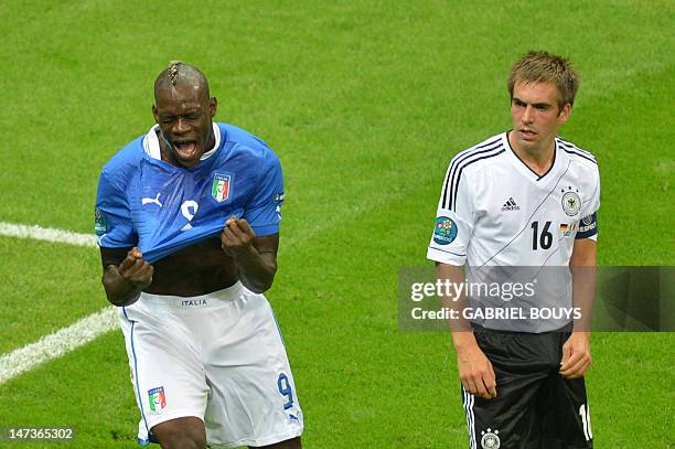 Italian forward Mario Balotelli celebrates next to German defender Philipp Lahm after scoring during the Euro 2012 football championships semi-final...