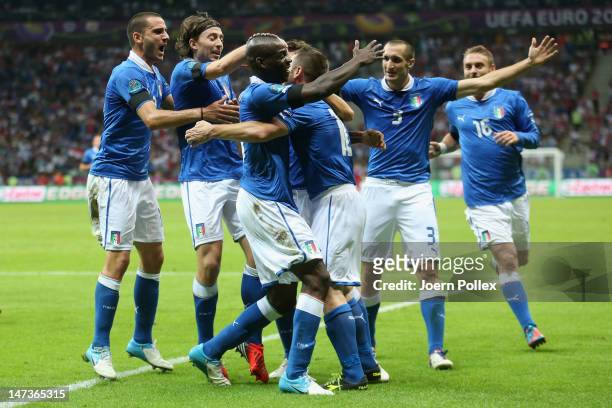 Mario Balotelli of Italy celebrates with team-mates after scoring the opening goal during the UEFA EURO 2012 semi final match between Germany and...