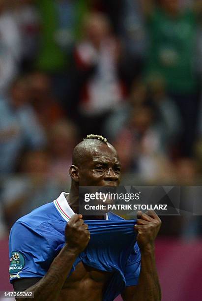 Italian forward Mario Balotelli reacts after scoring during the Euro 2012 football championships semi-final match Germany vs Italy on June 28, 2012...