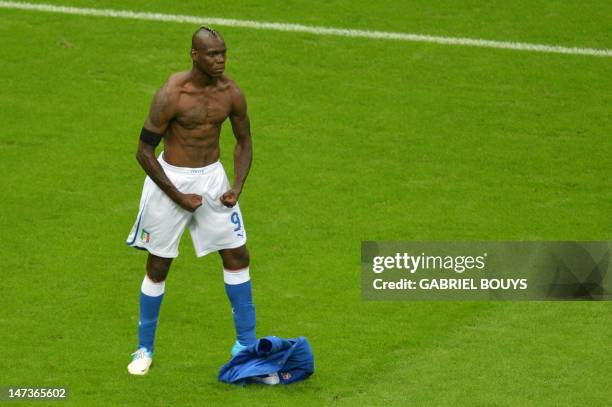 Italian forward Mario Balotelli celebrates after scoring the second goal during the Euro 2012 football championships semi-final match Germany vs...