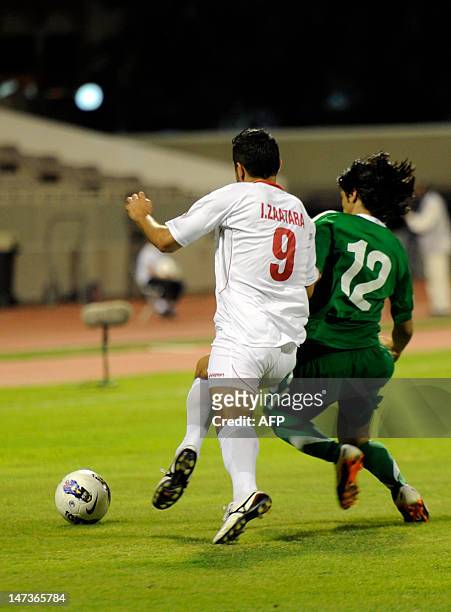 Palestine's Ahmed Hassan Zaatara vies for the ball against Saudi Arabia's Khalid al-Ghamdi during their Arab Cup football match in Saudi summer...