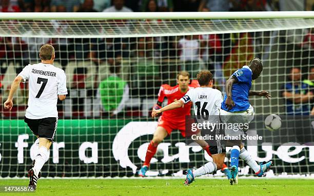 Mario Balotelli of Italy battles with Philipp Lahm of Germany as he scores his team's second goal past Manuel Neuer of Germany during the UEFA EURO...