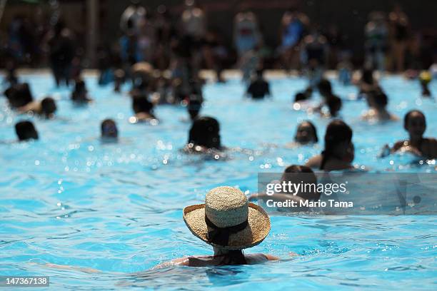 People bathe on opening day of the newly renovated McCarren Park Pool on June 28, 2012 in the Brooklyn borough of New York City. The historic 37,000...