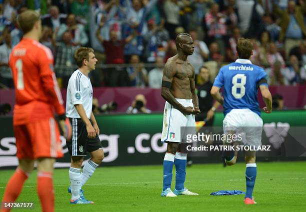 Italian forward Mario Balotelli reacts after scoring a goal during the Euro 2012 football championships semi-final match Germany vs Italy on June 28,...