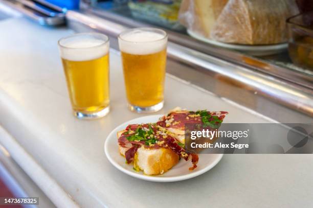 spanish tapas and beers on a bar counter in spain - madrid tapas stock pictures, royalty-free photos & images