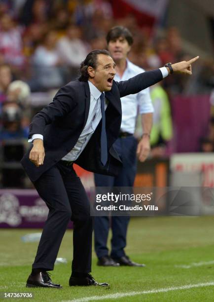 Head Coach Cesare Prandelli of Italy issues instructions to his players next to Head Coach Joachim Loew of Germany during the UEFA EURO 2012 semi...