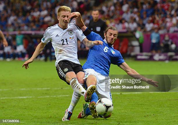 Marco Reus of Germany shoots at goal next to Federico Balzaretti of Italy during the UEFA EURO 2012 semi final match between Germany and Italy at the...