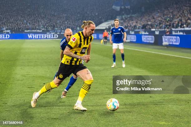 Marius Wolf of Dortmund runs with the ball during the Bundesliga match between FC Schalke 04 and Borussia Dortmund at Veltins-Arena on March 11, 2023...