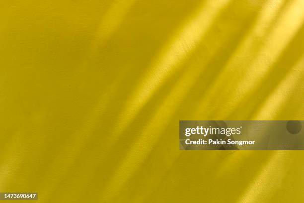 window shadow drop on yellow color old grunge wall concrete texture as background. - yellow wall stock-fotos und bilder