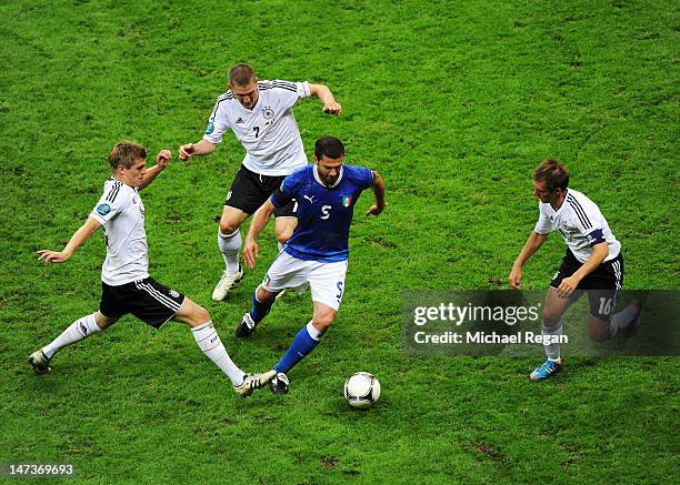 Thiago Motta of Italy is surrounded by Toni Kroos , Bastian Schweinsteiger and Philipp Lahm of Germany during the UEFA EURO 2012 semi final match...