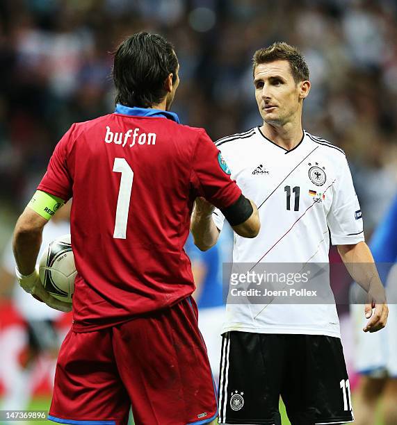 Gianluigi Buffon of Italy shakes hands with Miroslav Klose of Germany after the UEFA EURO 2012 semi final match between Germany and Italy at the...