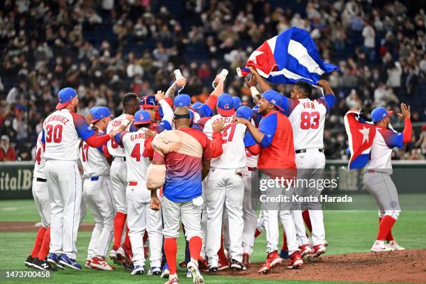 Cuba players celebrate the team's victory and the qualification for semifinals following the World Baseball Classic quarterfinal between Australia...