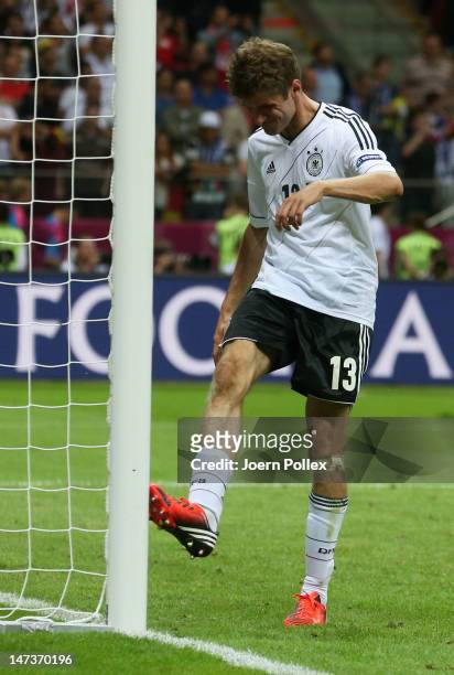 Thomas Muller of Germany kicks a goalpost as he shows his frustration after the UEFA EURO 2012 semi final match between Germany and Italy at National...