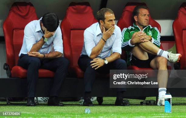 Head coach Joachim Loew of Germany and his assistant coach Hansi Flick show their dejection after the UEFA EURO 2012 semi final match between Germany...