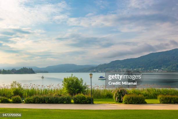 sailboats on lake woerthersee, daytime. klagenfurt, austria - kärnten am wörthersee stock pictures, royalty-free photos & images