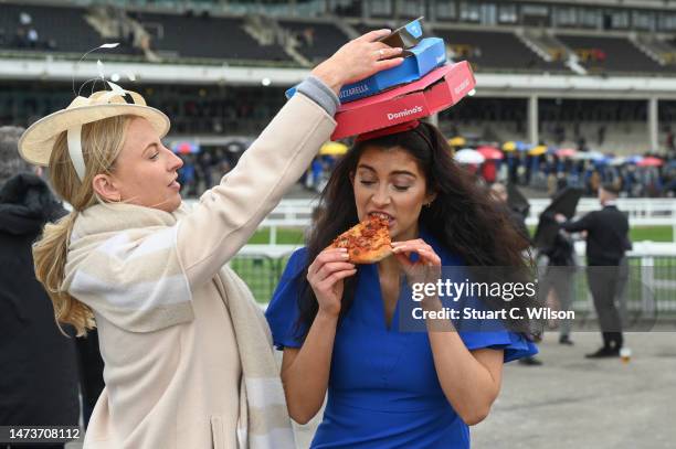 Pizza-loving racegoer attends Cheltenham Festival wearing a Domino's pizza inspired fascinator, at Cheltenham Racecourse on March 15, 2023 in...