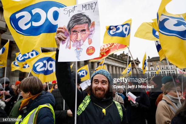 Members from the STUC, UCU, RMT and PCS unions gather on the mound for a rally in support of workers striking for better pay and conditions on March...