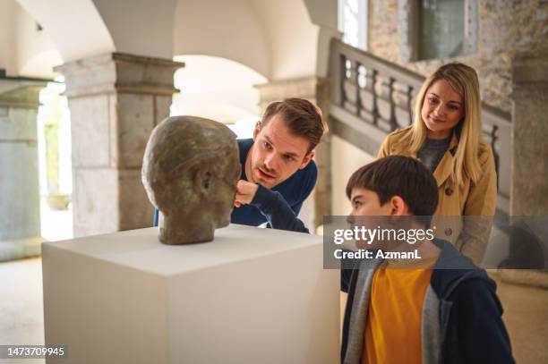 a boy and his big brother and sister at the gallery - family museum stock pictures, royalty-free photos & images