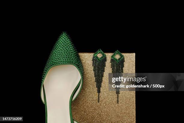 beautiful green woman shoes with brilliant isolated background,united kingdom,uk - editorial image stock pictures, royalty-free photos & images