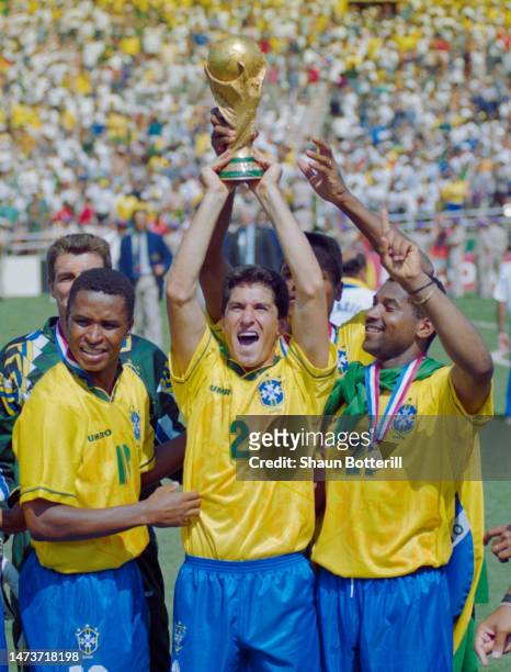 Paulo Sergio, Jorginho and Viola from Brazil celebrate with the FIFA World Cup Trophy after winning the 1994 FIFA World Cup Final between Italy and...
