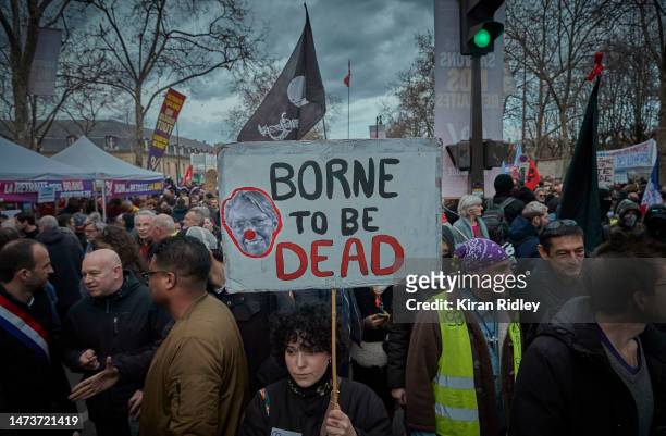 Protestor holds a placard that reads "Borne to be Dead" referring to the French Prime Minister Elizabeth Borne, as thousands take to the streets to...