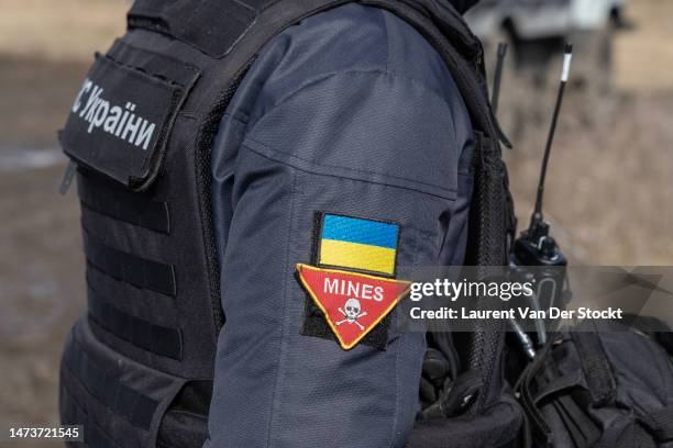 The badge of a Deminer from the DSNS sweep for mines on March 3,2023 around Lyman, Ukraine. Last February, Russia's military invaded Ukraine from...