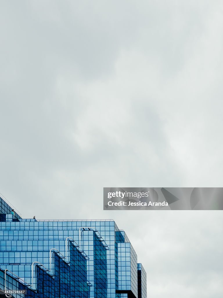Low Angle View Of Glass Building Against Sky