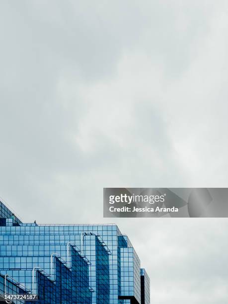low angle view of glass building against sky - londres inglaterra stockfoto's en -beelden