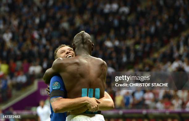 Italian forward Mario Balotelli celebrates with Italian forward Antonio Cassano during the Euro 2012 football championships semi-final match Germany...