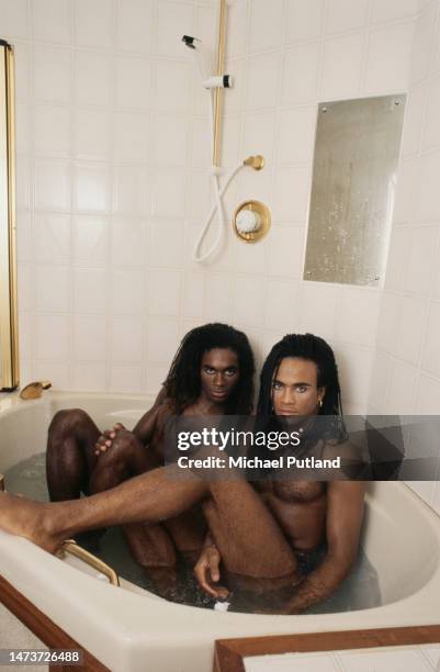 Singers Fab Morvan and Rob Pilatus of Franco-German R&B duo, Milli Vanilli, sharing a bathtub, Gun Wharves, Wapping, London, 27th September 1988.