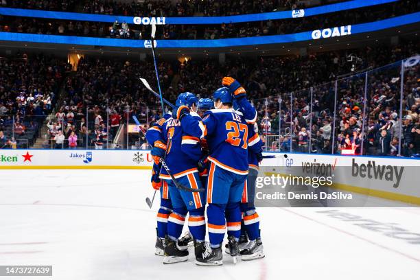 Anders Lee and Ryan Pulock of the New York Islanders celebrate a third period goal with teammates during the game between the Detroit Red Wings and...