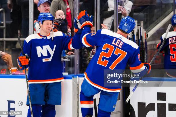 Matt Martin celebrates a win with teammate Anders Lee after the game between the Detroit Red Wings and the New York Islanders at UBS Arena on March...