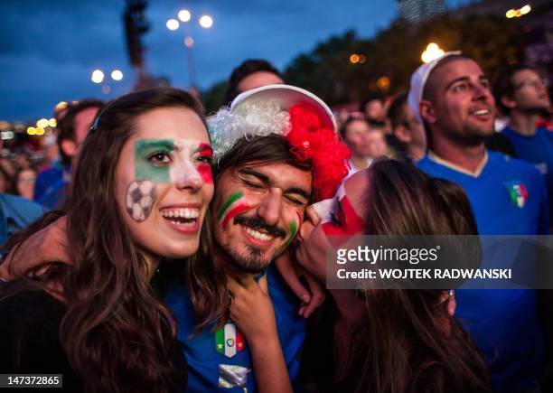 Italian football fans celebrate after a goal in the Warsaw Fanzone during the Euro 2012 semi-final match between Italy and Germany on June 28, 2012....
