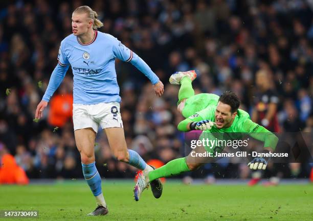 Erling Haaland of Manchester City clashes with Janis Blaswich of RB Leipzig during the UEFA Champions League round of 16 leg two match between...